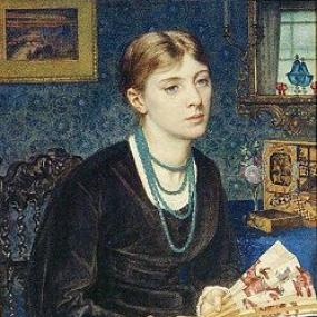 Photograph of a painting of Louisa Baldwin by Edward Poynter. The background (patterned wallpaper, a painting on the wall, ornaments) is mostly blue. She sits in a carved black chair, wearing a simple black dress with four strands of blue beads around her neck, and a paper fan clasped in her hands.