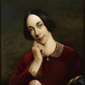 Photograph of a painting of Jane Welsh Carlyle by an unknown artist, at Carlyle's House in London. She is seen from the waist up, seated and looking down, with her head on one hand while the other holds a book. She wears a red velvet dress with lace at the collar and sleeves and a drop pearl at the neckline, as well as pearl bracelets and small gold rings. Her dark hair smooth, with a middle parting, and folded over her ears. National Trust'