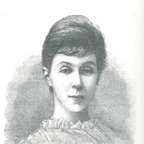 Black and white, head-and-shoulders print of Margaret Harkness full face, wearing a high-necked blouse or dress, hair back behind her ears.