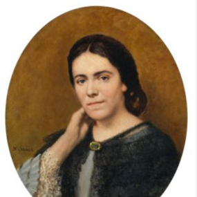 Photograph of a head-and-shoulders, oval painting of Julia Kavanagh by Henri Chanet, c.1874-6. She is set against a gold-coloured background, wearing a blue-grey dress with lace trimmed, ruffled sleeves, and a dark blue shawl  fastened with a brooch. Her dark hair is loosely gathered at the nape of her neck. She rests her chin on one hand and gazes serenely at the viewer.