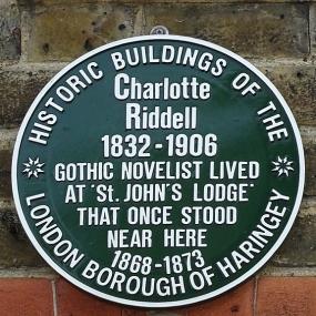 "Historic Buildings of the London Borough of Haringey" green plaque at St Ann's Hospital, Tottenham, London, reading: "Charlotte Riddell 1832-1906 Gothic novelist lived at 'St John's Lodge' that once stood here 1863-1873."