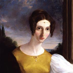 Photograph of a painting of Harriet Taylor by an unidentified artist, c. 1834. She is seen from the waist up against a backdrop of trees and sky. She wears a gown with yellow bodice and hugely puffed white sleeve. Her dark, smooth hair, centre-parted, is done in a bun behind and ringlets at her ears. A thin gold chain sits round her forehead, with a red gem at its centre matching another gem and drop pearl at her neckline. He face is stylised, with big eyes and a startled look. National Portrait Gallery.