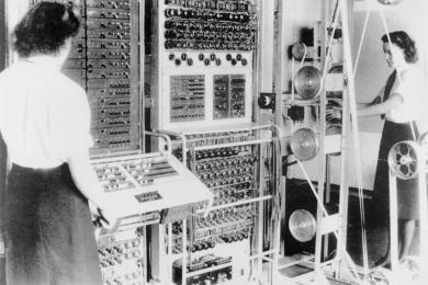 black and white photo of two women operating a mid 20 century computer