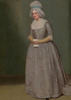Photo of a full-length painting of Leah Sumbel by Samuel de Wilde, performing (under her original name, Mary Wells) as Anne Lovely in Susannah Centlivre's "A Bold Stroke for a Wife". She stands on stage, wearing a long, plain grey dress laced up the bodice, its square neckline filled with a fichu, Her hair is powdered under a tall mob cap with a blue ribbon, and she holds a paper in her hands.