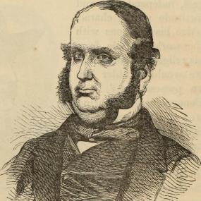 Henry Thomas Buckle, with a chin beard, wearing a formal suit.