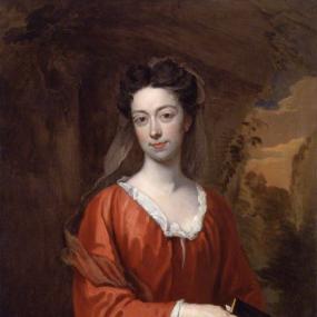 Photograph of a painting of Elizabeth Burnet by Sir Godfrey Kneller, c. 1707. She is depicted standing, with an outdoor background of trees, resting an elbow on pedestal. One hand is at her side; the other hand holds a small book. She is wearing a red-orange dress with white lace at the neckline and wrists, and she has her brown hair in waves on her head, with a gauzy veil trailing behind. National Portrait Gallery