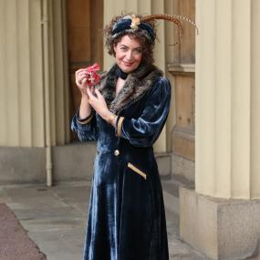 Photo of Kate Clanchy outside Buckingham Palace, London, shortly after being appointed a member of the Order of the British Empire for
            services to literature, 7 February 2019.