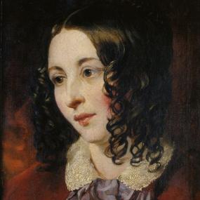 Photograph of a head-and-shoulders painting of Eliza Cook by William Etty, c. 1845. She is shown with her head turned to the side, wearing a red jacket over a white blouse with a large lace collar and a mauve bow tied in the centre. Her dark hair, smooth on top and centre-parted, hangs in loose ringlets around her face.