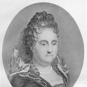 Black and white engraved portrait of Anne Dacier. She is facing the viewer, though turned to her left a little. She wears a gown with lace detailing along the neckline and collar, with a head-dress attached at the back of her head; her hair is gathered there, and falls around her shoulders. Her expression is neutral.