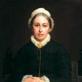 Photograph of a painting of Emily Davies by Rudolph Lehmann, 1880, seated with her hands clasped in her lap. She is wearing a dark green dress, with white ruffles at the sleeves and neckline, and a white cap on her head.