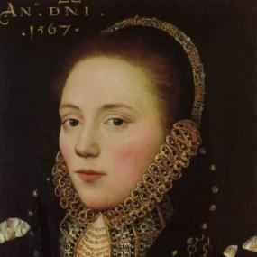 Portrait painting of Anne Dowriche, dated 1567. She faces the viewer on a slight angle, with a slightly tense expression. She wears a heavy, dark, ornamented gown with a high, stiff ruffled collar that encircles her jawline and joins to an ornate headband, and her hair is pulled back from her face.