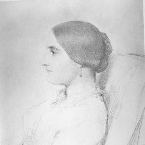 Black and white, head-and-shoulders sketch of Lucie Duff Gordon  in profile by George Frederic Watts, c. 1848, used as frontispiece to Duff Gordon's "Letters From Egypt", 1865. She sits in an armchair, facing to the left, wearing a loose gown with a high neckline, and her smooth hair is pulled back into a low bun.  Below is her signature, "Lucie Duff Gordon".
