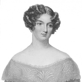Black and white reproduction of an unknown artist's portrait of Catherine Gore, 1848. Her hair is in short curls with a middle parting, and she is wearing a dress with a large floral-patterned collar, that leaves her shoulders bare.