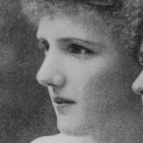 Black and white, close-up photograph of Eva Gore-Booth in profile; it appears to be cropped from a larger group photo. Her hair is bushy and pinned up.