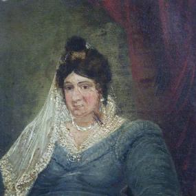 Painting by William Watkeys, 1835, of Ann Hatton sitting with a book under her left hand. Her hair is in a bun with a veil tied in it, draping down her right shoulder. She is wearing a blue dress. The painting seems to have some sort of damage in the form of a slash over her cheek. Glynn Vivian Art Gallery, Swansea.