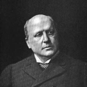 Henry James in  a black-and-white photo by  William M. Vander Weyde. James is seen full-face, looking forward and to the left, wearing a formal suit, with bald head slightly tilted.