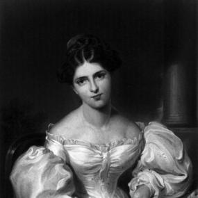Black and white photograph of a painting of Fanny Kemble by Sir Thomas Lawrence, She is seated in a chair draped with a fur-trimmed blanket, with a column visible in the background. She is wearing a white gown, low on her shoulders, with wasp waist, puffed sleeves, and ruffled trim. Her dark, shining hair, smooth and middle-parted, is pulled back in a bun.