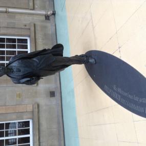 Statue of Philip Larkin by Martin Jennings at Hull Paragon railway station in Yorkshire, unveiled 2 December 2010. Larkin is mid stride, holding a book under one arm and a hat in his other hand.