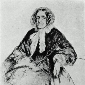 Photograph of a drawing of Jane Marcet, seated, wearing a dress with a broad skirt and wide sleeves. She has a scarf wrapped around her head and tied at her neck, and her hair is middle-parted and tightly curled in ringlets.