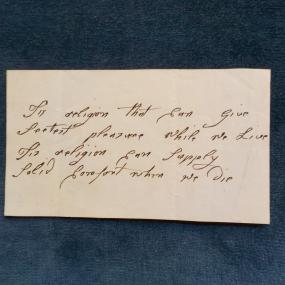 A photograph of four lines of a poem by Mary Masters, written in an early, unidentified hand, beginning: "Tis religion that can give / S[w]eetest pleasure while we Live . . . ."