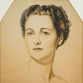 Head-and-shoulders drawing of Nancy Mitford by William Acton, 1937. Her dark, wavy hair is parted in the centre; her bare shoulders rise smoothly from the background.