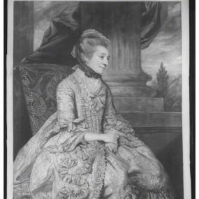 Mezzotint of Elizabeth Montagu, published by John Raphael Smith in 1776 after a painting by Sir Joshua Reynolds. She is seen in profile, sitting in a large upholstered chair against a backdrop of drapery, a pillar, and an outdoor landscape. Her dress and petticoat are voluminous and heavily decorated, with ruffled sleeves and a bow at the neck. Her hair is brushed back under a small bonnet perched on top of her head and tied with a dark ribbon. Below the image is a coat of arms and italic writing: "Mrs. Mon