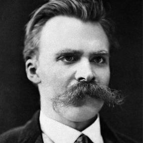 Black-and-white, head-and-shoulders photograph of Friedrich Nietzsche,  looking straight at the camera with a large handlebar moustache.