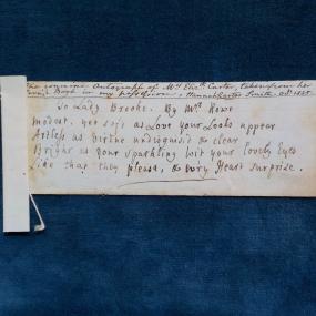 Transcription by Elizabeth Carter of a poem by Elizabeth Rowe, on paper surrounded by a deep blue background. "To Lady Brooke" reads in part: "your Looks appear / Artless as Virtue undisguised &amp; clear / Bright as your sparkling Wit your lovely Eyes / Like that they please . . . .”