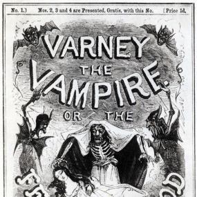 Photograph of cover of the book Varney the Vampire, or the Feast of Blood. The image is black and white and depicts a skeletal being (presumably the titular vampire) in cloak, standing ominously over a sleeping woman. On either side there is a drawing of a demonic-looking creature with bat-like wings. At the bottom of the image a graveyard is depicted. The text on the cover notes that this book is "by the author of Grace Rivers, or the Merchant's Daughter."