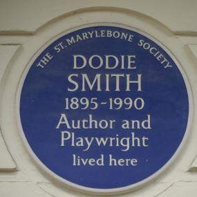 Photograph of a blue plaque set up on the stone white-painted ground floor wall of 18 Dorset Square, Marylebone, London NW1 6QB by the St Marylebone Society, reading "Dodie Smith, 1895-1990, Author and Playwright lived here."
