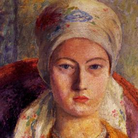 Photo of a head-and-shoulders, brightly coloured painting of Julia Strachey by Dora Carrington, 1925. She looks straight forward, sitting in a red and purple chair and wearing a yellow shirt, double string of pearls, and faintly but colourfully patterned scarf and hat or turban.