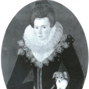 Black and white photo of a half-length oval painting of Lady Arbella Stuart perhaps by Robert Peake the elder. Facing forward in a stiff pose, she wears a dark bodice with white bead detail around the waist and down the front, and white lace collar surrounding a white ruff. She has a little dog tucked under her left arm; her right hand holds an ornate lidded watch, to signify that time is fleeting and life short. Her dark chestnut hair, brushed back, has a black cap on top and decoration hanging along her f
