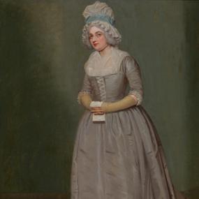 Photo of a full-length painting of Leah Sumbel by Samuel de Wilde, performing (under her original name, Mary Wells) as Anne Lovely in Susannah Centlivre's "A Bold Stroke for a Wife". She stands on stage, wearing a long, plain grey dress laced up the bodice, its square neckline filled with a fichu, Her hair is powdered under a tall mob cap with a blue ribbon, and she holds a paper in her hands.