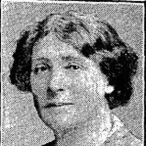 Black and white photograph of Annie S. Swan, shown from the shoulders up. She is wearing a collared shirt with dark, wavy, chin-length hair.