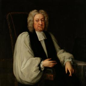 Painting of an older Jonathan Swift, who is posed sitting in a high-backed chair.