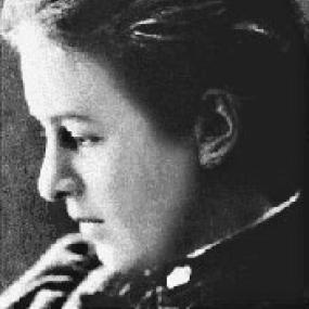 Black and white head-shot of Evelyn Underhill, in profile with her gaze downcast. Her hair is smoothed back.