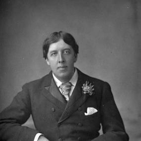 Black and white photograph of Oscar Wilde sitting