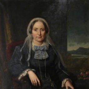 Photo of a painting of Ellen Wood by Sydney Hodges. Wood is seated on a red chair gazing straight at the viewer. Her left hand holds a book; she is wearing a blue dress with lace trim around the sleeves and neck, and a lighter blue bow around the collar. Her cap has a broad, sheer ribbon running down from it. She wears a necklace, and a ring on her right index finger. A window behind her opens on a mountain landscape.