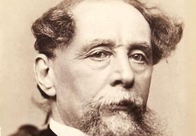 Head-and-shoulders daguerrotype of Charles Dickens by Jeremiah Gurney of New York City, 1867-8. Dickens has a goatee beard, moustache, and hair combed forward on each side of his bald patch.