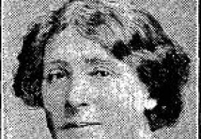 Black and white photograph of Annie S. Swan, shown from the shoulders up. She is wearing a collared shirt with dark, wavy, chin-length hair.